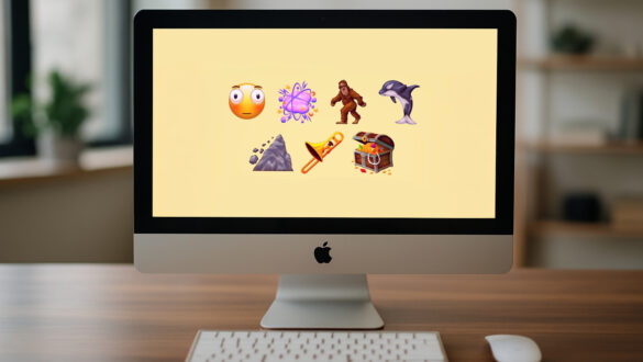 iMac на дерев’яному столі в офісі; на екрані — нові емодзі Unicode 17.0: перекошене обличчя, хмара бійки, косатка, волохате створіння, зсув, тромбон і скриня зі скарбами; попереду клавіатура й миша.